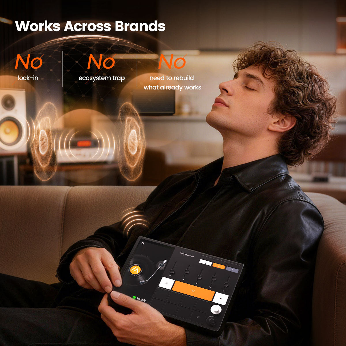 Man sitting on a couch using a tablet with text about brand compatibility.